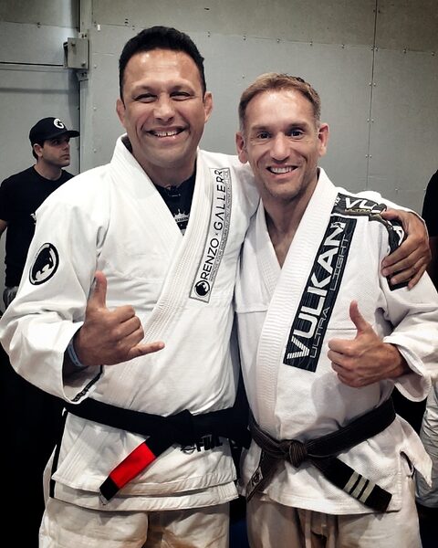 Our head instructor in a Brazilian jiu-jitsu gi with BJJ black belt legend Renzo Gracie after training.