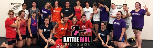 A women's fitness kickboxing class at Rumble Martial Arts throwing a front kick in unison, Battle Girl Bootcamp.