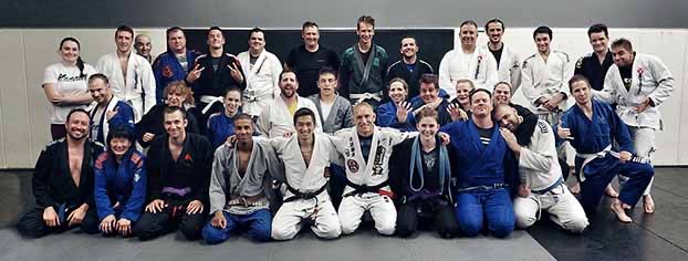 A large Brazilian Jiu-Jitsu class group photo at Rumble Martial Arts — students and coaches of mixed belt ranks in gi.