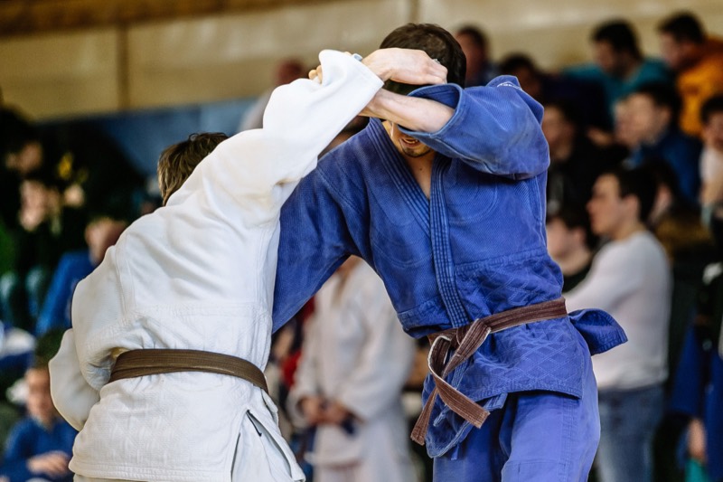 A judo-style grappling takedown in action on the mats at Rumble Martial Arts.